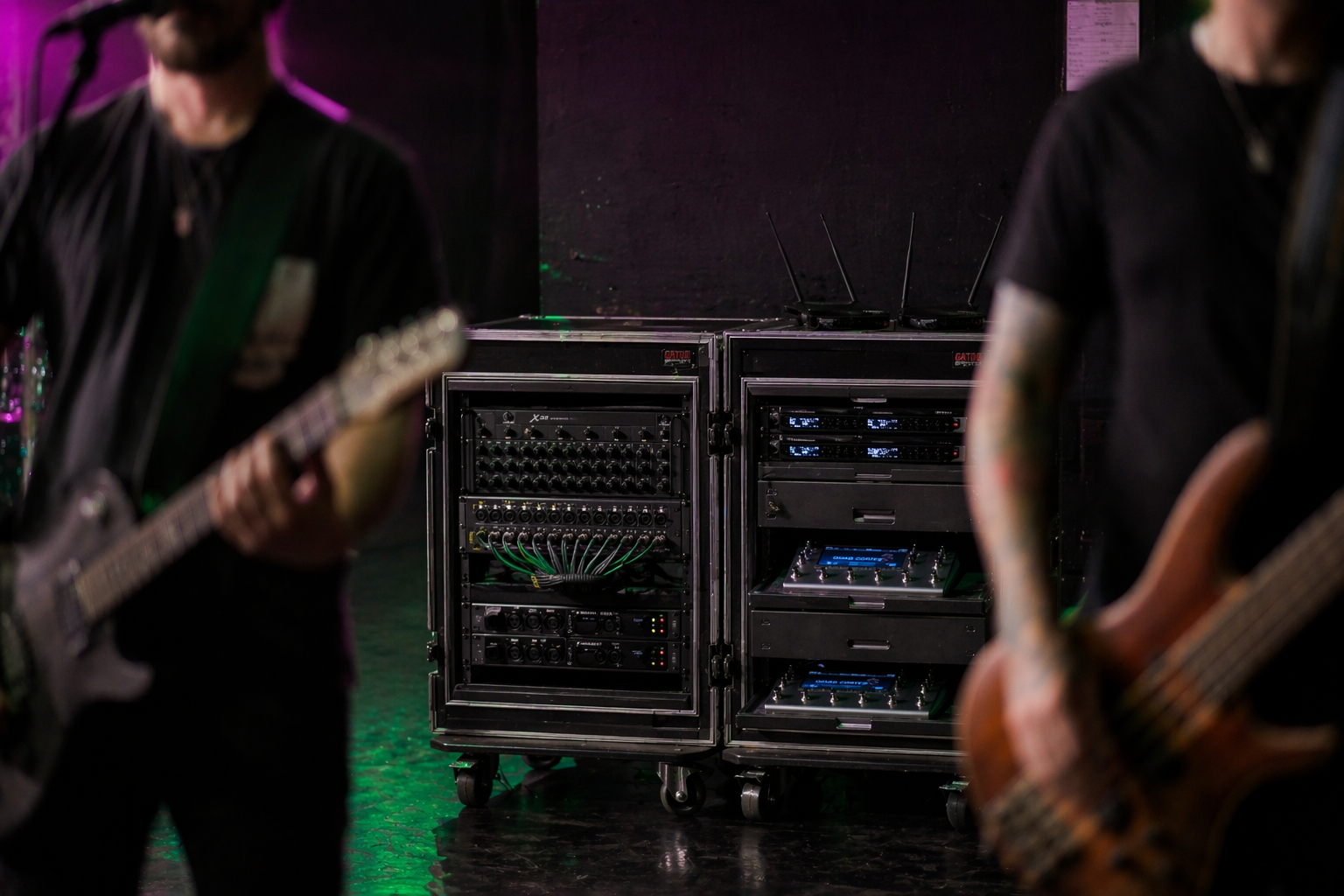 Band performing on stage with equipment racks for live playback and monitoring